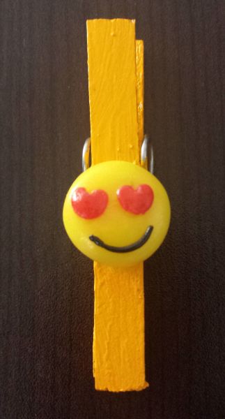 Prendedor amarelo decorado com emoticon apaixonado